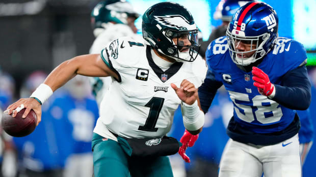New York Giants linebacker Bobby Okereke (58) goes after Philadelphia Eagles quarterback Jalen Hurts (1) just before sacking him in the second quarter, Sunday, January 7, 2024.